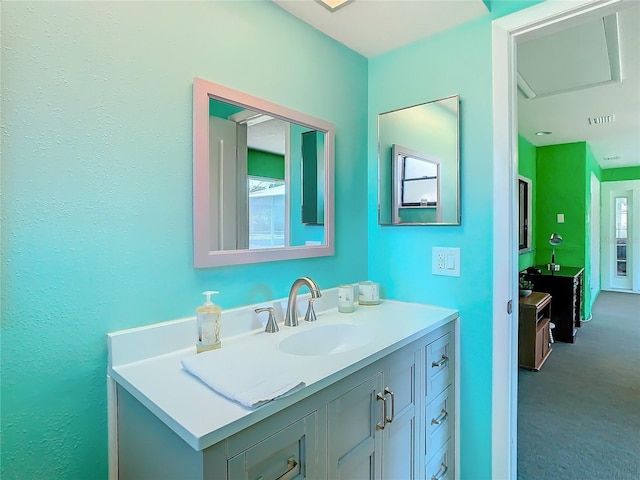 bathroom featuring plenty of natural light, visible vents, and vanity