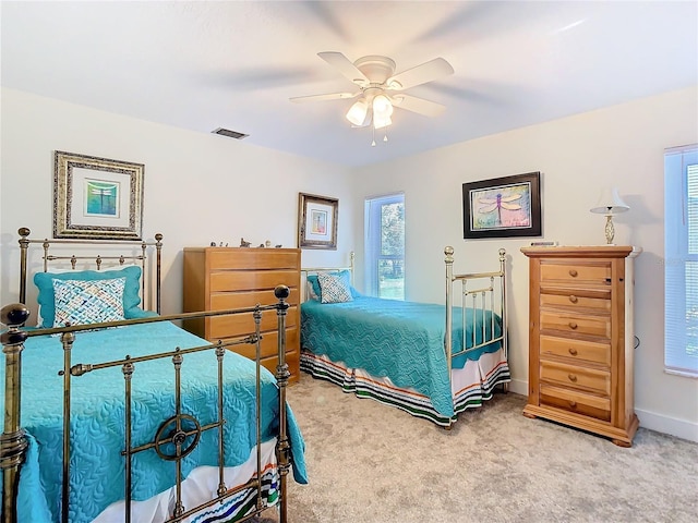 bedroom with a ceiling fan, baseboards, visible vents, and carpet flooring