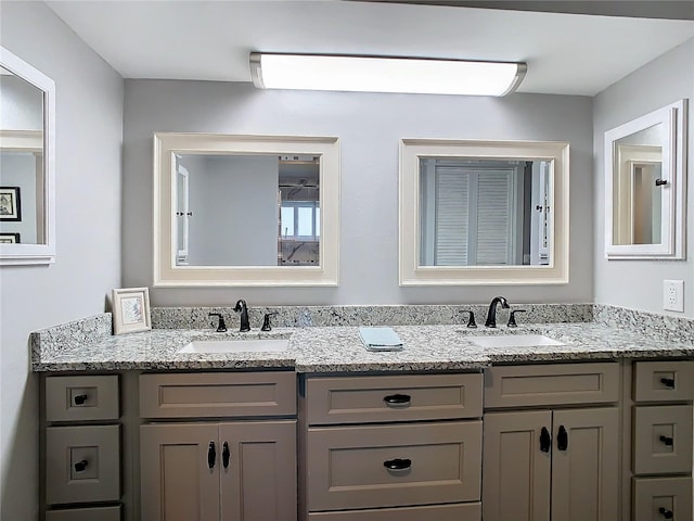 full bath with a sink and double vanity