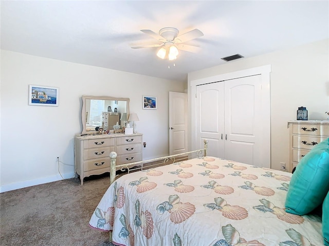 carpeted bedroom featuring baseboards, ceiling fan, visible vents, and a closet