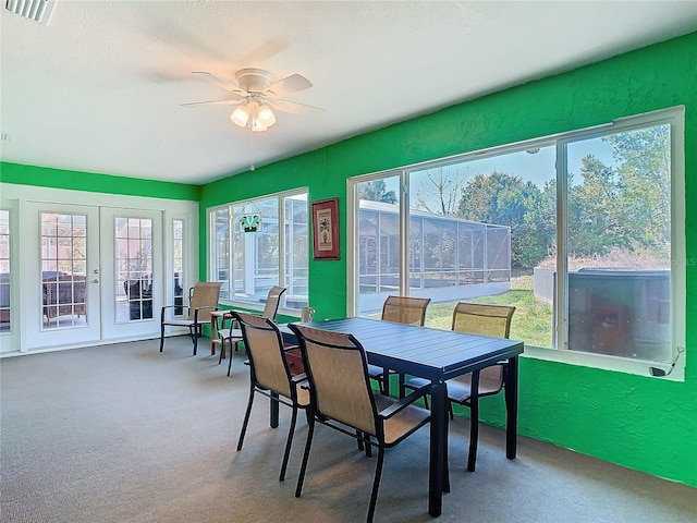 sunroom featuring french doors, visible vents, and a ceiling fan