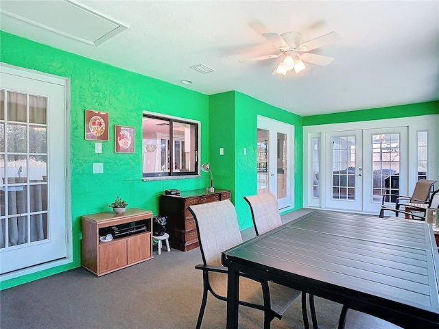 dining area featuring visible vents, a textured wall, ceiling fan, french doors, and carpet floors