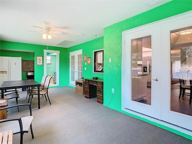 office space featuring carpet, visible vents, a ceiling fan, and french doors