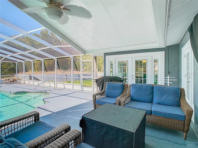 sunroom / solarium featuring ceiling fan and french doors