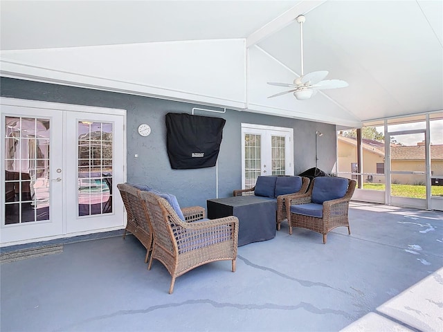 sunroom featuring lofted ceiling with beams, ceiling fan, and french doors