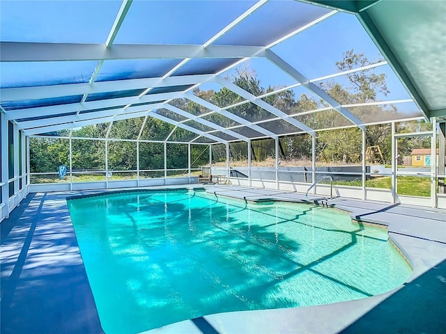 outdoor pool featuring a patio area and glass enclosure