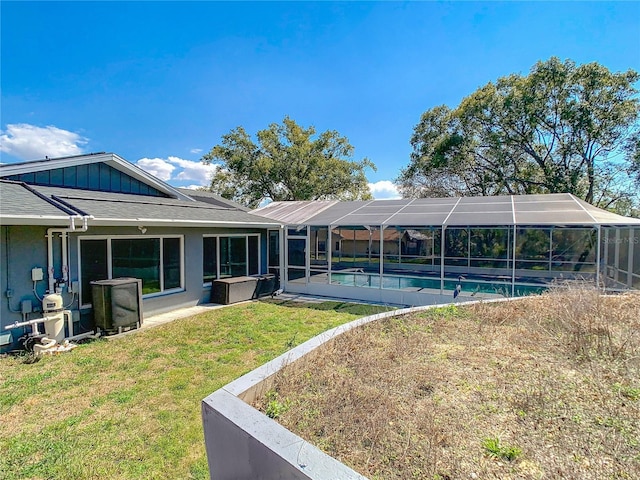 view of yard with a lanai and an outdoor pool