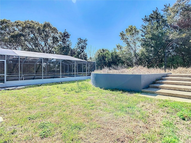 view of yard with glass enclosure