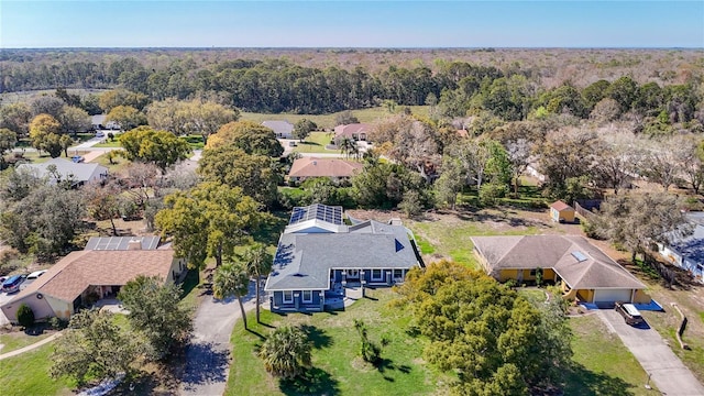 birds eye view of property featuring a view of trees