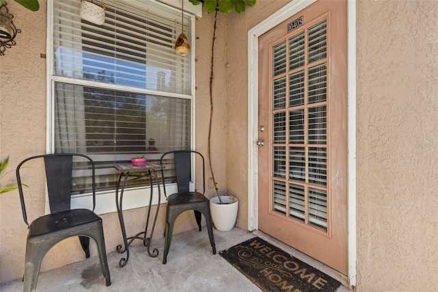 doorway to property with stucco siding