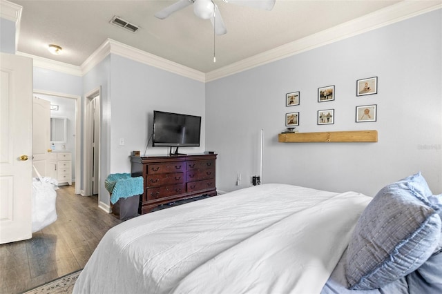 bedroom featuring ceiling fan, wood finished floors, visible vents, and ornamental molding