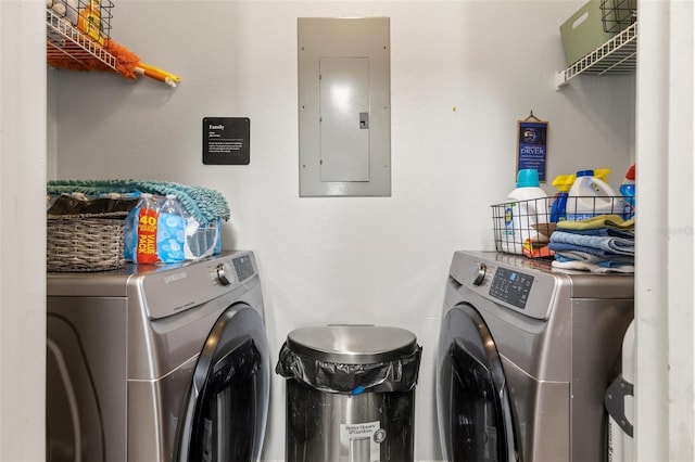 washroom featuring washer and dryer, laundry area, and electric panel