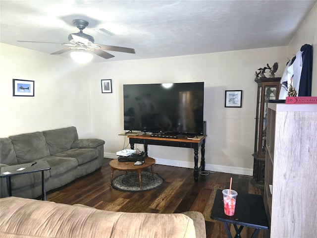 living area featuring visible vents, wood finished floors, baseboards, and ceiling fan