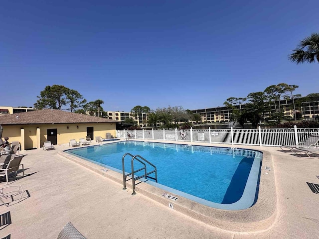 pool featuring fence and a patio