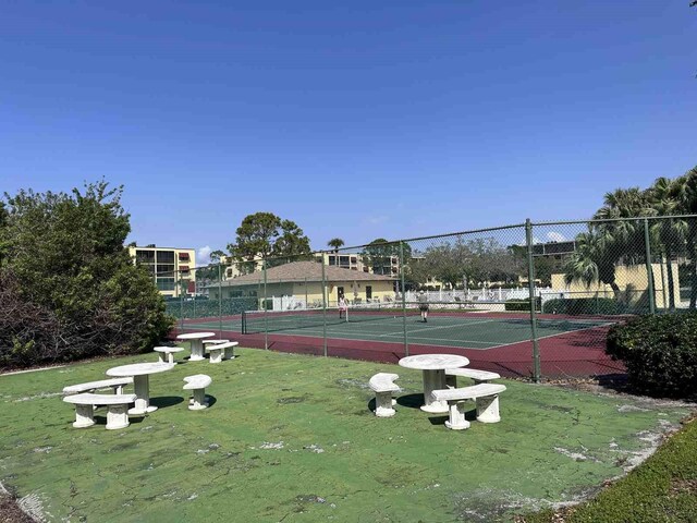 view of sport court featuring fence