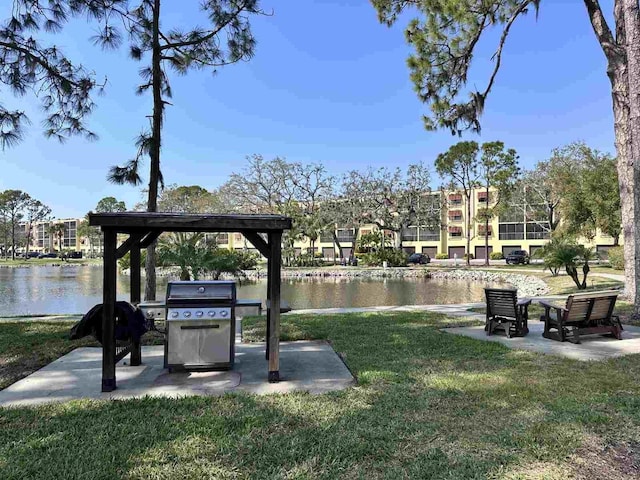 view of property's community with a water view and a yard