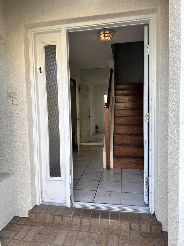 property entrance with stucco siding