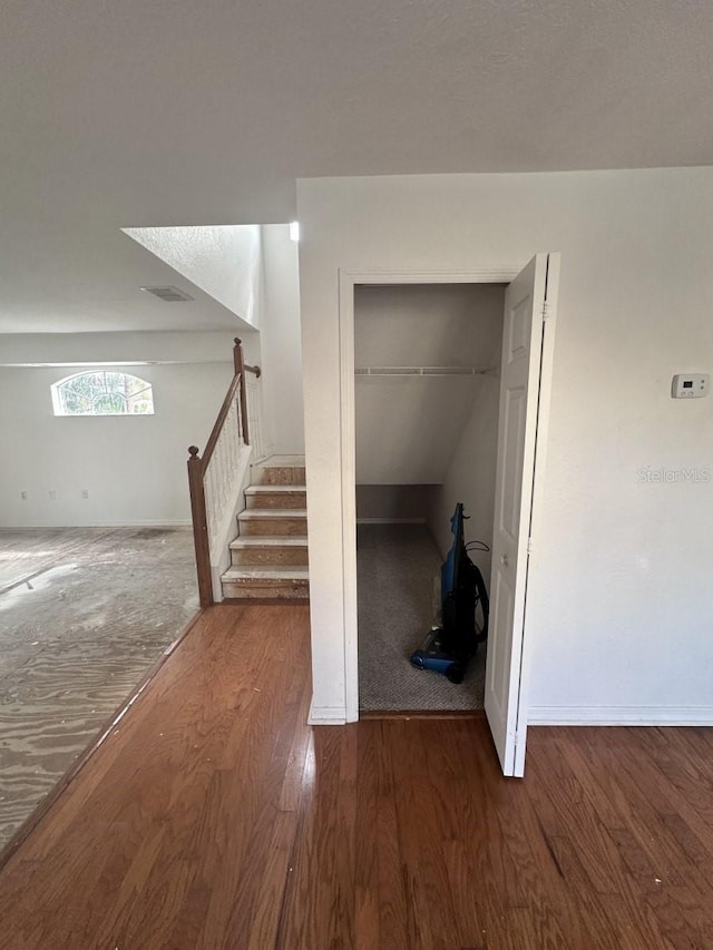 interior space featuring baseboards and wood finished floors