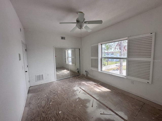 unfurnished bedroom featuring a closet, visible vents, and multiple windows