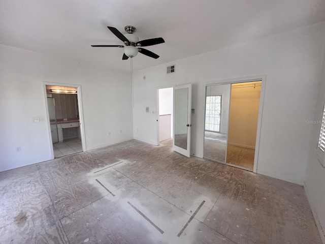 unfurnished bedroom with visible vents, ceiling fan, and ensuite bathroom