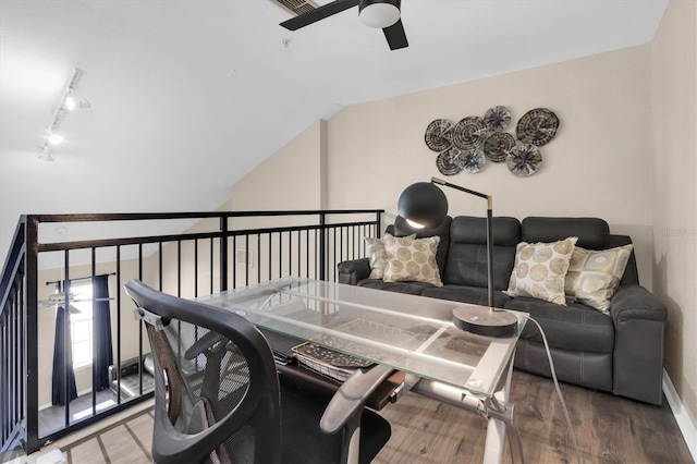 living area featuring lofted ceiling, ceiling fan, wood finished floors, and track lighting