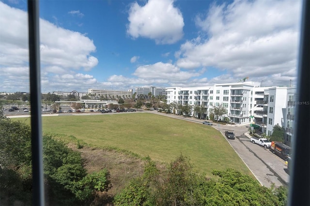 view of property's community featuring a view of city and a lawn