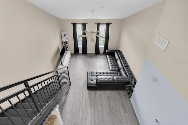 interior space featuring visible vents, ceiling fan, baseboards, and wood finished floors