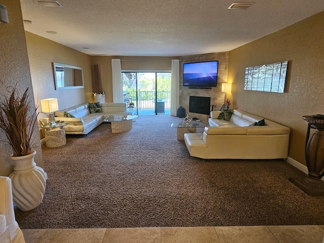530 Sandy Hook Rd, Treasure Island, FL 33706 - carpeted living room featuring a textured wall, a fireplace, visible vents, and a textured ceiling