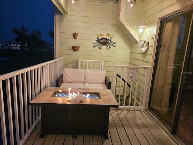 530 Sandy Hook Rd, Treasure Island, FL 33706 - view of wooden balcony featuring an outdoor fire pit and a deck