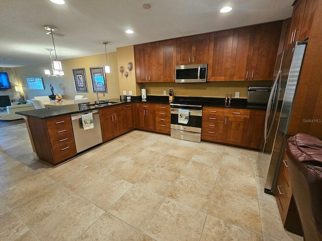 530 Sandy Hook Rd, Treasure Island, FL 33706 - kitchen featuring hanging light fixtures, open floor plan, dark countertops, a peninsula, and stainless steel appliances