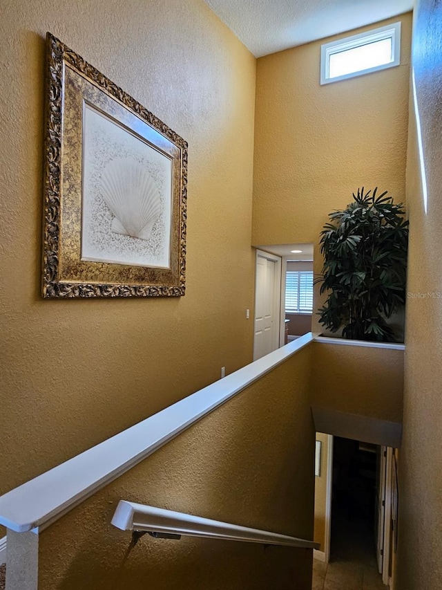 530 Sandy Hook Rd, Treasure Island, FL 33706 - stairway featuring a textured wall and tile patterned flooring