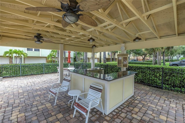 530 Sandy Hook Rd, Treasure Island, FL 33706 - view of patio / terrace with outdoor dry bar, ceiling fan, and fence