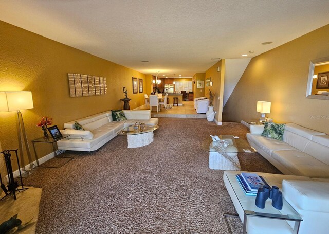 530 Sandy Hook Rd, Treasure Island, FL 33706 - carpeted living area featuring baseboards, a textured wall, and a textured ceiling