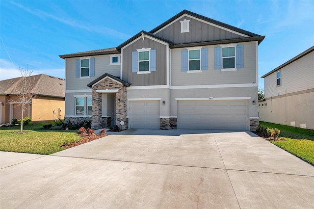 craftsman inspired home featuring an attached garage, driveway, stone siding, board and batten siding, and a front yard