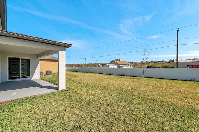 view of yard with central AC, a patio area, and fence