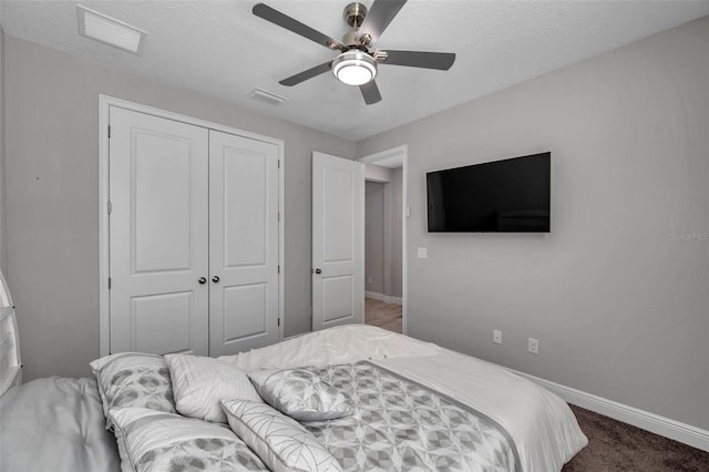 bedroom with a closet, carpet, visible vents, and baseboards