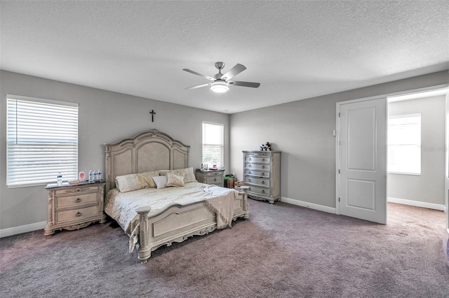 carpeted bedroom with a textured ceiling, ceiling fan, and baseboards