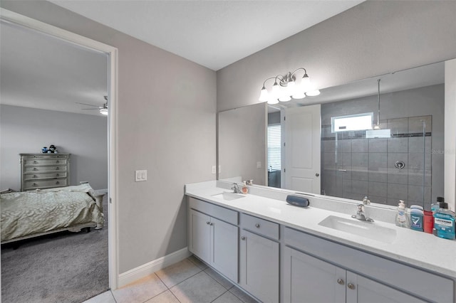 ensuite bathroom featuring ensuite bathroom, double vanity, a sink, and tile patterned floors