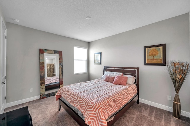 bedroom featuring a textured ceiling, carpet, and baseboards