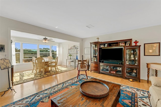 living area featuring ceiling fan and wood finished floors