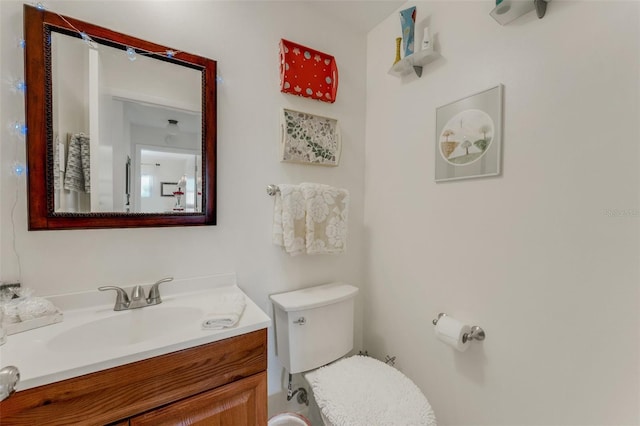 half bathroom with toilet and vanity