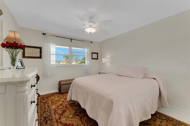 bedroom featuring ceiling fan and baseboards