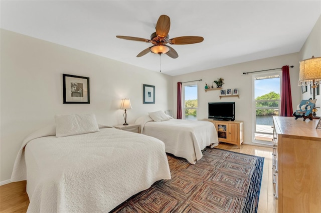 bedroom with ceiling fan, access to outside, and light wood finished floors