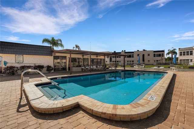 community pool featuring a patio area, ceiling fan, and fence