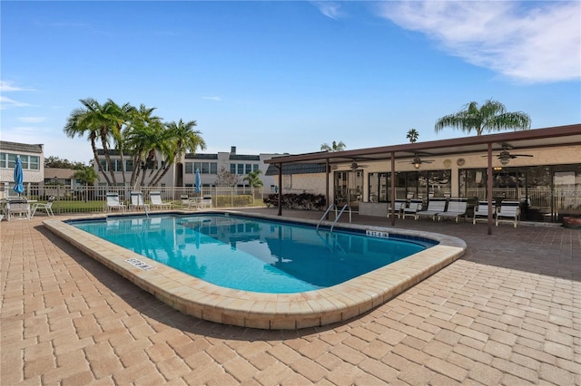 community pool featuring a patio area, fence, and a ceiling fan