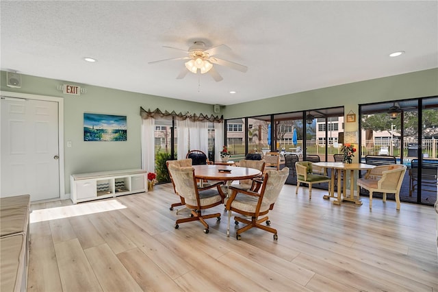 dining space with a ceiling fan, recessed lighting, a textured ceiling, and wood finished floors