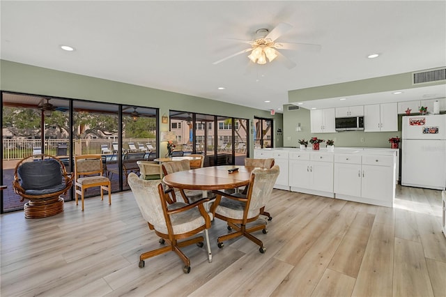 dining space featuring light wood-style floors, recessed lighting, visible vents, and a ceiling fan