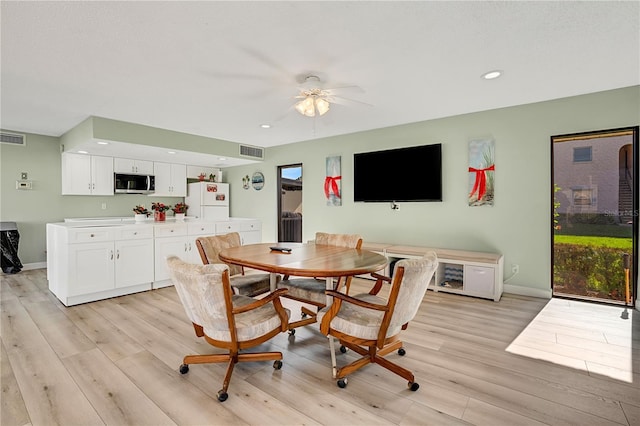 dining space with light wood-type flooring, visible vents, baseboards, and recessed lighting