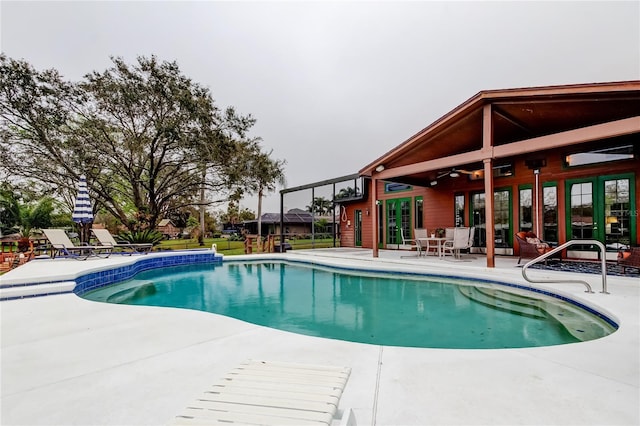 outdoor pool featuring a ceiling fan and a patio