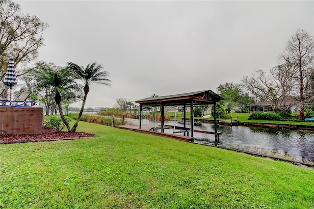 dock area featuring a yard, a water view, and boat lift